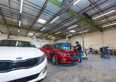 Buffing a finish on a Mazda auto body repair